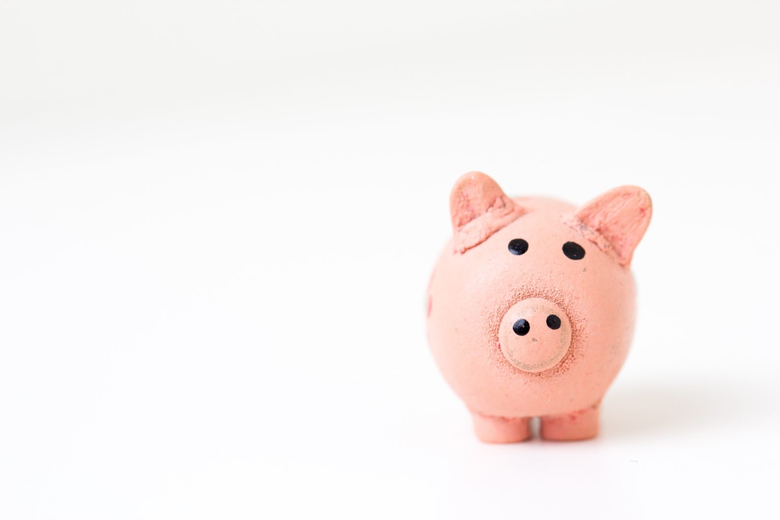 Pink piggy bank against white background